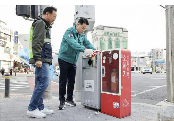 오언석 도봉구청장이 담배꽁초 전용 수거함에 버려진 담배꽁초를 수거하고 있다