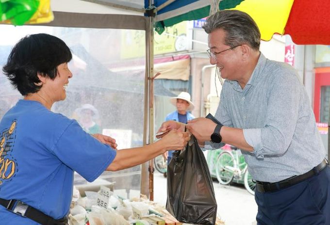 정용래 유성구청장이 29일 유성시장에서 민생 회복 소비 쿠폰으로 장을 보고 있다.